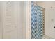 Bathroom featuring blue patterned curtains, toilet, and closet at 6540 Kenwood Dr, North Port, FL 34287