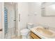 Bathroom featuring a sink, toilet, and a shower featuring blue patterned curtains at 6540 Kenwood Dr, North Port, FL 34287