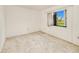 Bright bedroom featuring a window with natural light and neutral carpet at 6540 Kenwood Dr, North Port, FL 34287