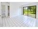 Open bedroom featuring sliding glass doors with outdoor views and tile floor at 6540 Kenwood Dr, North Port, FL 34287