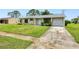 Quaint single-Gathering home with a well-maintained lawn and driveway at 6540 Kenwood Dr, North Port, FL 34287