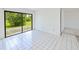 Open living area with tile floors, light-filled with sliding glass doors, creating a bright and airy atmosphere at 6540 Kenwood Dr, North Port, FL 34287