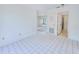 Bright living room with white tile flooring, leading to the bathroom and living area at 6540 Kenwood Dr, North Port, FL 34287