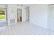 Bright living room with white tile flooring leading to the bathroom and entryway at 6540 Kenwood Dr, North Port, FL 34287