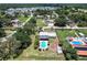 Aerial view showcasing the property with a pool, a shed, and mature trees at 8513 Heister St, Punta Gorda, FL 33982