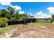 Expansive backyard featuring an in-ground pool, lush greenery, and a serene outdoor space for leisure and recreation at 8513 Heister St, Punta Gorda, FL 33982
