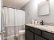 This bathroom features an elegant countertop and a shower behind a patterned curtain at 8513 Heister St, Punta Gorda, FL 33982
