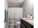 This bathroom features an elegant countertop and a shower behind a patterned curtain at 8513 Heister St, Punta Gorda, FL 33982