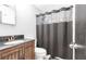 This bathroom features wood cabinets and a tub behind a curtain at 8513 Heister St, Punta Gorda, FL 33982