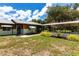View of a charming single-story home with a metal roof, carport, and a well-maintained front yard at 8513 Heister St, Punta Gorda, FL 33982