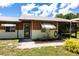 Charming home exterior featuring awnings, landscaping, and a relaxing screened-in porch on a sunny day at 8513 Heister St, Punta Gorda, FL 33982