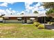Charming single-story home with a metal roof, carport, and a well-maintained front yard under a sunny sky at 8513 Heister St, Punta Gorda, FL 33982
