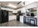 Bright kitchen with white cabinetry, black appliances, and a convenient breakfast bar seating area at 8513 Heister St, Punta Gorda, FL 33982