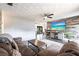 Comfortable living room with a large sectional sofa, stylish entertainment center, and modern wood-look floors at 8513 Heister St, Punta Gorda, FL 33982