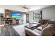 Cozy living room showcasing a TV, a comfortable sofa, and a large window with natural light at 8513 Heister St, Punta Gorda, FL 33982