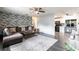 Modern living room featuring a stylish brick wall, cozy brown sectional sofa and contemporary decor at 8513 Heister St, Punta Gorda, FL 33982