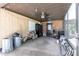 Enclosed patio with rustic wood paneling, ceiling fan, and various storage solutions, ideal for outdoor utility and relaxation at 8513 Heister St, Punta Gorda, FL 33982