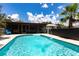Inviting in-ground pool with clear water and fountain feature, framed by lush greenery and the home's screened lanai at 8513 Heister St, Punta Gorda, FL 33982