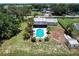 Aerial view of a house featuring a sparkling swimming pool, palm trees and screened in patio at 8513 Heister St, Punta Gorda, FL 33982