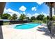 Refreshing in-ground pool with clear blue water and surrounding landscaping, perfect for summer relaxation and outdoor activities at 8513 Heister St, Punta Gorda, FL 33982