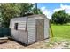 Exterior shot of backyard shed featuring light colored siding and a side window on a sunny day at 8513 Heister St, Punta Gorda, FL 33982