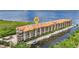 Aerial view of a waterfront condo building with boat docks and lush landscaping at 900 E Marion Ave # 1203, Punta Gorda, FL 33950