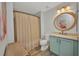 Updated bathroom with stylish vanity, round mirror, and shower with tub at 900 E Marion Ave # 1203, Punta Gorda, FL 33950