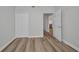 Well-lit bedroom with hardwood floors, closet, and view to kitchen area at 900 E Marion Ave # 1203, Punta Gorda, FL 33950