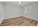 Bedroom with hardwood floors, white trim, and a window offering natural light at 900 E Marion Ave # 1203, Punta Gorda, FL 33950