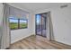 Bright bedroom with wood-look floors, and a slider door to the balcony with water views at 900 E Marion Ave # 1203, Punta Gorda, FL 33950