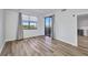 Bright bedroom with wood-look floors, and a slider door to the balcony with water views at 900 E Marion Ave # 1203, Punta Gorda, FL 33950