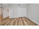 Cozy bedroom with hardwood floors, closet, and view to ensuite bathroom at 900 E Marion Ave # 1203, Punta Gorda, FL 33950