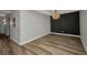 Open dining room with hardwood floors, modern lighting, and accent wall at 900 E Marion Ave # 1203, Punta Gorda, FL 33950