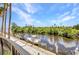 Waterfront property featuring private dock with boat lifts surrounded by lush greenery at 900 E Marion Ave # 1203, Punta Gorda, FL 33950