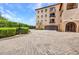 Building exterior featuring a paver parking area and lush landscaping at 900 E Marion Ave # 1203, Punta Gorda, FL 33950