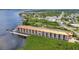 Waterfront condo building with views, attached garage parking, and tropical landscaping at 900 E Marion Ave # 1203, Punta Gorda, FL 33950