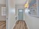 Hallway with wood floors, gray walls and a blue front door at 900 E Marion Ave # 1203, Punta Gorda, FL 33950