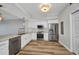 A modern kitchen with stainless steel appliances, white cabinets and wood floors at 900 E Marion Ave # 1203, Punta Gorda, FL 33950