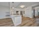 A bright kitchen featuring white cabinets, stainless steel appliances and wood floors at 900 E Marion Ave # 1203, Punta Gorda, FL 33950