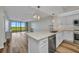 Open kitchen with granite countertops, stainless steel appliances and a living room view at 900 E Marion Ave # 1203, Punta Gorda, FL 33950