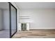 Living room with glass door, hardwood floors, custom bar, and shelving at 900 E Marion Ave # 1203, Punta Gorda, FL 33950