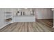 A living room featuring wood floors, modern decor, and an open floor plan to kitchen at 900 E Marion Ave # 1203, Punta Gorda, FL 33950