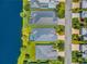 Aerial view featuring multiple homes with pools and well-maintained landscaping near the waterway at 10478 Coquina Ct, Placida, FL 33946