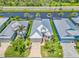 Aerial view of a beautiful home with lush landscaping and brick paver driveway at 10478 Coquina Ct, Placida, FL 33946