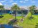 Backyard showing screened lanai with a pool and green lawn leading to the water at 10478 Coquina Ct, Placida, FL 33946