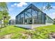 Expansive backyard with a screened lanai, pool, and pond views at 10478 Coquina Ct, Placida, FL 33946