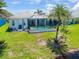 A well-maintained yard and pool area with screened in lanai at 10478 Coquina Ct, Placida, FL 33946