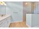 Bathroom with quartz countertops, and a tiled glass shower enclosure at 10478 Coquina Ct, Placida, FL 33946