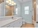 Light-filled bathroom with a double-sink vanity, large mirror, and tiled shower at 10478 Coquina Ct, Placida, FL 33946