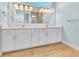 Bathroom with double vanity, quartz countertop, and large mirror at 10478 Coquina Ct, Placida, FL 33946